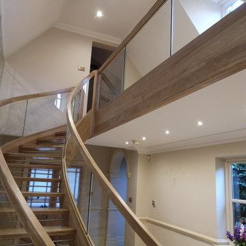 Curved Oak Stairs with Glass Balustrade