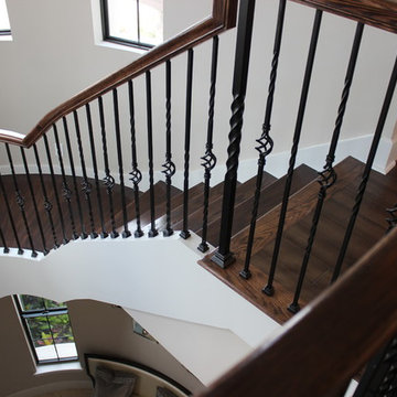Curved Red Oak Stair with Single Basket & Twist Iron Balusters