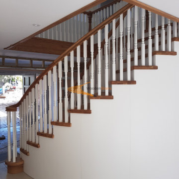 Curved solid Oak and painted Birch staircase with curved under-stair storage