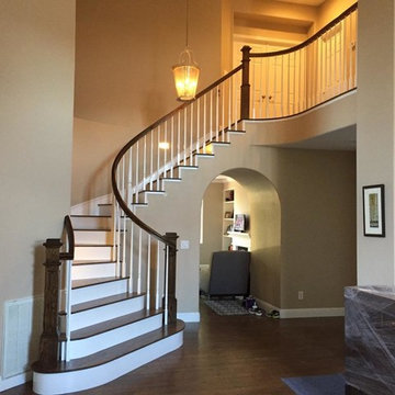 Curved Stair with Box Newels, Stained Treads, and Painted Risers