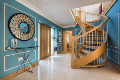Photo of a classic wood curved wood railing staircase in Other.