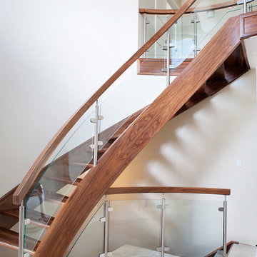Curved Walnut Stair With Curved Glass