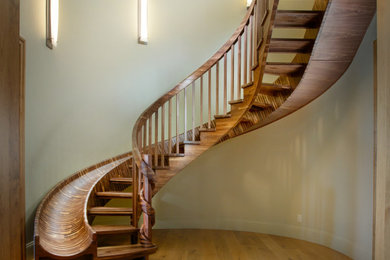 Huge eclectic wooden curved open and wood railing staircase photo in Sacramento