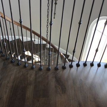 Custom Circular 3-Story Walnut Stair With Iron BalustersS
