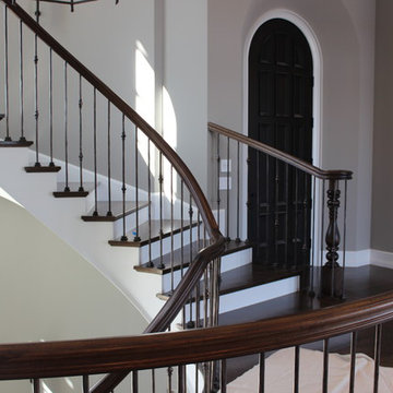 Custom Circular 3-Story Walnut Stair With Iron BalustersS