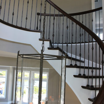 Custom Circular 3-Story Walnut Stair With Iron BalustersS