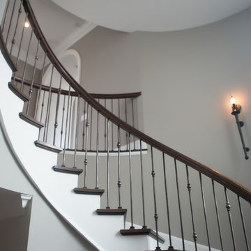 Custom Circular 3-Story Walnut Stair With Iron BalustersS