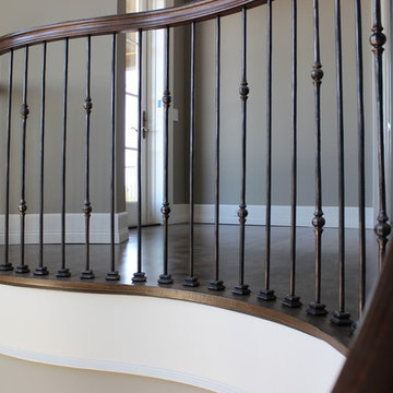 Custom Circular 3-Story Walnut Stair With Iron BalustersS