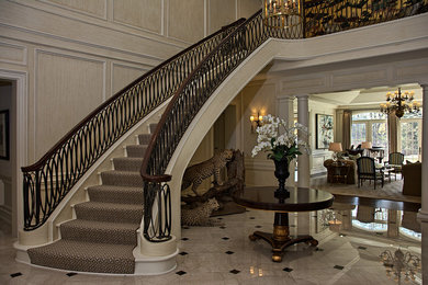 Staircase - large contemporary carpeted curved staircase idea in Detroit with carpeted risers