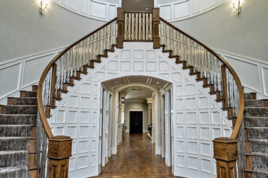 Inspiration for a huge timeless carpeted curved mixed material railing staircase remodel in Oklahoma City with carpeted risers