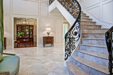 Large elegant curved staircase photo in Raleigh