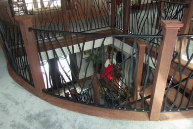 Inspiration for a mid-sized rustic wooden curved staircase remodel in Other with wooden risers