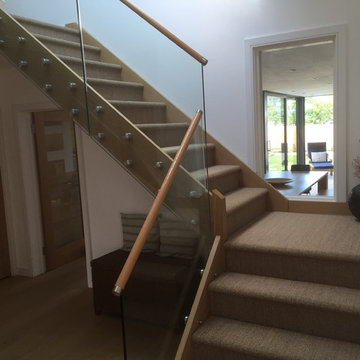 Custom made staircase in oak, glass and stainless steel glass adapters