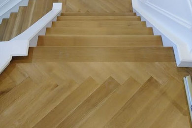 Inspiration for a large transitional wooden l-shaped staircase remodel in Other