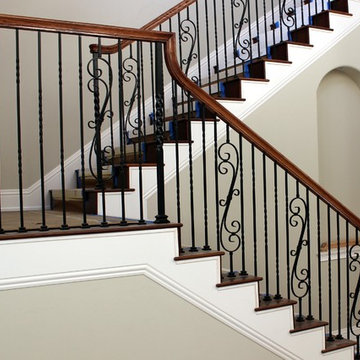 Custom stair with wrought iron balusters & wood handrail