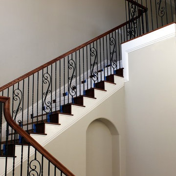 Custom stair with wrought iron balusters & wood handrail