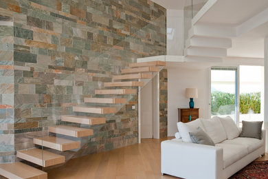 Inspiration for a contemporary wooden floating open and glass railing staircase remodel in New York