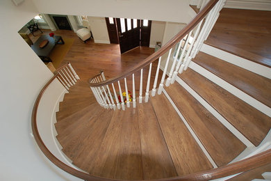 Inspiration for a mid-sized timeless wooden curved wood railing staircase remodel in Los Angeles with painted risers