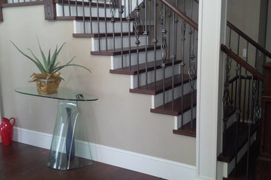 Example of a mid-sized classic wooden l-shaped metal railing staircase design in Vancouver with painted risers