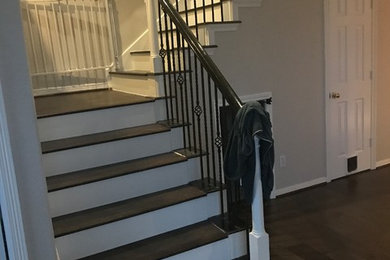 Design ideas for a medium sized traditional wood l-shaped metal railing staircase in Houston with painted wood risers.