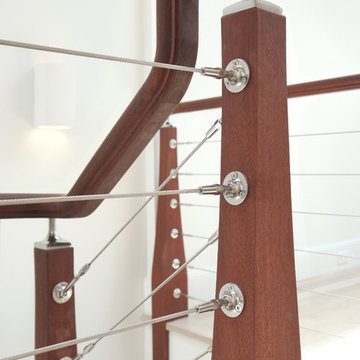 dark wood staircase with wire cables