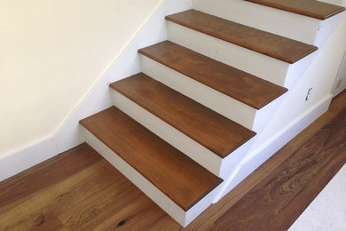 Staircase - traditional wooden straight staircase idea in Other with painted risers