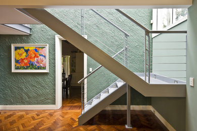 Diseño de escalera en U minimalista de tamaño medio sin contrahuella con escalones de metal y barandilla de cable