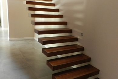 Design ideas for a medium sized contemporary wood floating staircase in London with wood risers.