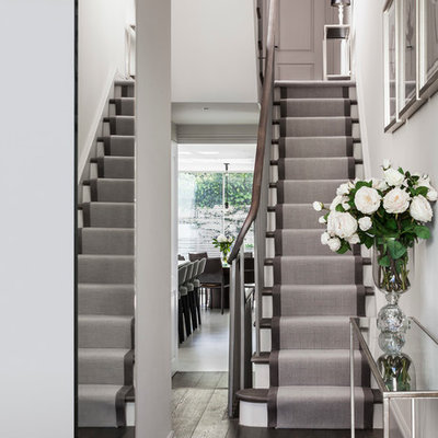Staircase - small contemporary painted l-shaped staircase idea in London with painted risers