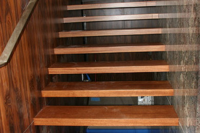 Example of a trendy wooden floating open staircase design in Las Vegas