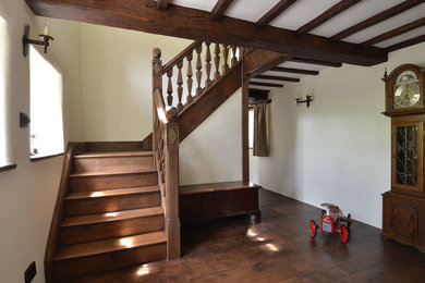 Medium sized classic wood staircase in Other with wood risers.