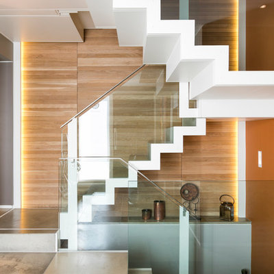 Example of a trendy painted u-shaped staircase design in London with painted risers