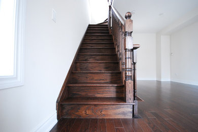 Medium sized traditional wood straight staircase in Toronto with wood risers.