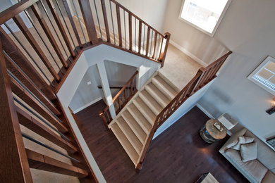 Arts and crafts carpeted straight staircase photo in Calgary with carpeted risers