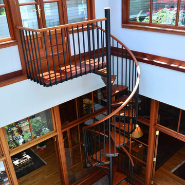 Elegant Steel Spiral Stair with Mahogany Tread, Rail, and Platform - Duvinage