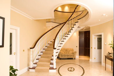 Large traditional wood spiral staircase in Other with wood risers.