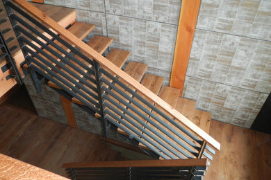 Trendy wooden straight open staircase photo in Other