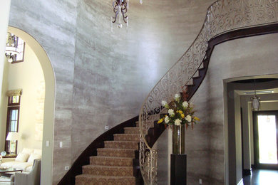 Large elegant carpeted curved staircase photo in Los Angeles with carpeted risers