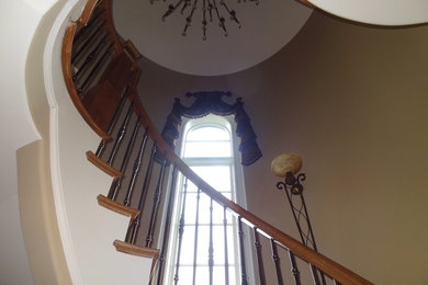 Diseño de escalera en U clásica grande con escalones con baldosas y contrahuellas de madera