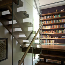 Neat bookcase in landing wall of staircase.