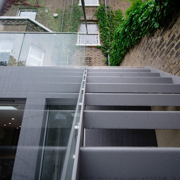 External Open Riser stairs with perforated treads and glass balustrade
