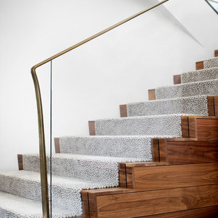 Example of a trendy wooden u-shaped metal railing staircase design in Austin with carpeted risers