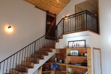Inspiration for a mid-sized cottage wooden straight metal railing staircase remodel in Other with wooden risers