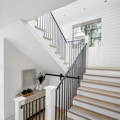 Staircase - coastal wooden u-shaped metal railing staircase idea in Orange County with painted risers