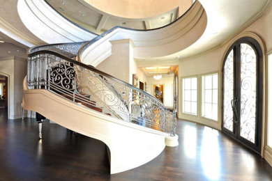 Example of a mid-sized tuscan wooden spiral metal railing staircase design in Dallas with wooden risers