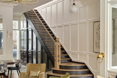 Foto de escalera recta clásica renovada con escalones de madera, barandilla de varios materiales y panelado