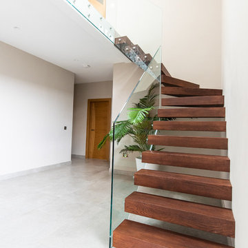 Floating stairs with frameless glass balustrade to stairs run and landing