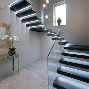Floating treads staircase with glass balustrades to the stairs and top landing