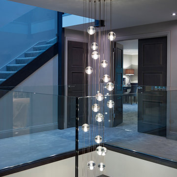 Floating treads staircase with glass balustrades to the stairs and top landing