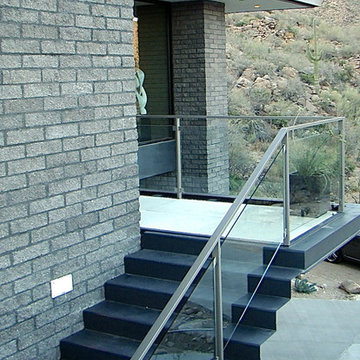 folded steel ribbon stairway leading to entry balcony around the corner
